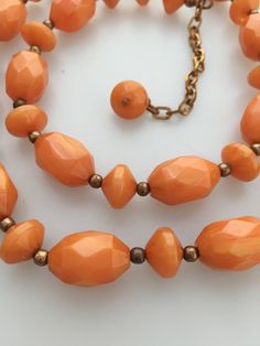 "Here is a lovely late 50s/early 60s vintage faceted Bakelite beaded necklace. This piece came out of a jewelry store that I bought out over 30 years ago. The Bakelite is a butterscotch color. The lovely faceted beads are very geometric and accented with smooth Bakelite beads as well as goldstone spacers. The beads were tested positive for Bakelite with simichrome polish. The necklace measures 22\" long with a 4 extender chain. The necklace was never worn and in excellent vintage condition."