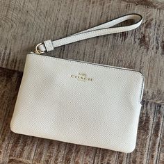 Coach White Wristlet Nwt White Rectangular Clutch With Zipper Closure, Elegant White Clutch With Zipper Closure, White Pouch Wristlet With Zipper Closure, White Clutch Wristlet With Zipper Closure, White Clutch With Wrist Strap For Everyday Use, Chic White Wristlet With Zipper Closure, Elegant Cream Clutch With Zipper Closure, Chic Cream Coach Wristlet, Elegant Beige Coach Wristlet