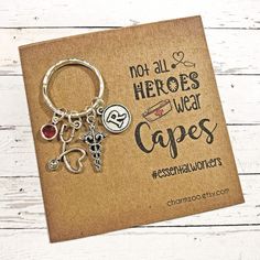 a card with a keychain that says not all hero's wear capes