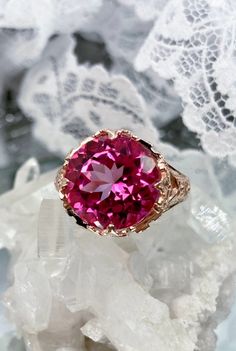 Natural Pink Topaz Ring Princess Design#29 Custom Made Inspired by Georgian and Victorian era filigree designs, I now offer this stunning reproduction in sterling silver with rose gold overlay. This fabulous ring is set with a 7.4ct VVS natural genuine pink topaz gemstone. The round full cut high quality gemstone is 13mm (1/2th of an inch) in diameter. The gemstone has excellent color and clarity. The inside of the band is marked 925 for sterling. Notice the beautiful intricate leaf prongs and f Fine Jewelry Rose Gold Topaz Ring With Accent Stones, Rose Gold Topaz Ring With Accent Stones, Heirloom Rose Gold Topaz Gemstone Ring, Formal Rose Gold Topaz Ring With Accent Stones, Elegant Rose Gold Topaz Birthstone Ring, Rose Gold Topaz Jewelry With Accent Stones, Rose Gold Topaz Ring With Accent Stones For Gift, Elegant Pink Topaz Gemstone Ring, Rose Gold Topaz Gemstone Ring