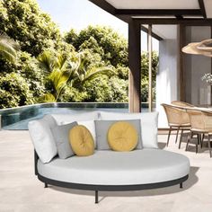 an outdoor living room with white furniture and yellow pillows