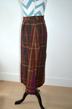 This is a great vintage skirt from the 1950s. It appears to have been handmade due to hand stitching inside the skirt, and there are no labels. Made of wool plaid fabric and lined with polyester. Plaid is rich in fall hues of browns, purple, hunter green, and red. Perfect for the holiday season and winter. It appears to fit a small- see measurements below.waist- 25"hip- 44"length- 29" Plaid Wool Skirt, Wool Skirt, Brown Plaid, Plaid Fabric, Green And Red, Wool Skirts, The 1950s, Wool Plaid, Hunter Green