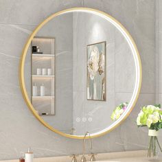 a bathroom sink with a round mirror above it and flowers in vases on the counter