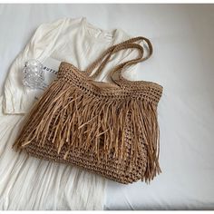 Get ready to bask in the sun and embody the essence of summer with our Striped Beach Straw Bag. Handmade with love, this spacious shoulder bag is a captivating blend of raffia and rattan, exuding the carefree vibes of a beach vacation. With its large capacity and casual yet chic design, it's the perfect tote bag for your leisurely escapades. Carry your essentials in style, whether you're strolling along sandy shores or exploring a vibrant coastal town. Let the allure of our Straw Bag elevate you Summer Woven Sand-colored Shoulder Bag, Summer Style Sand-colored Shoulder Bag, Sand-colored Shoulder Bag For Summer Travel, Spring Beach Sand-colored Straw Bag, Sand-colored Straw Bag For Summer Beach, Vacation Shoulder Bag, Eco-friendly Brown Shoulder Bag For Vacation, Large Capacity Beige Hobo Bag For Vacation, Vacation Hobo Bag In Beige Bucket Style