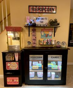 a display case with popcorn and soda machines