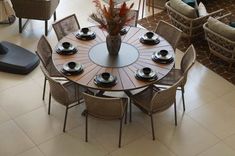 a round table with chairs and plates on it