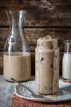 two jars filled with iced coffee sitting on top of a table