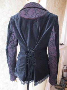 Fabulous Joe Browns velvet jacket with 3 silver buttons to close and a black lace trim at the hem.  The collar is maroon and black tweed which is also on the cuffs and pockets  and inside of sleeve.  The back waist has a black ribbon to lace up.  The lining inside is black with cream flowers.  Excellent condition. Bust,  pit to pit;  20" Inside sleeve;  18" Length;  27" Made by JOE BROWNS Long Sleeve Velvet Costume Outerwear, Long Sleeve Velvet Outerwear For Costume, Gothic Long Sleeve Velvet Outerwear, Black Gothic Velvet Outerwear, Black Velvet Gothic Outerwear, Gothic Fitted Velvet Outerwear, Fitted Gothic Velvet Outerwear, Velvet Costume Outerwear For Fall, Velvet Outerwear For Costume