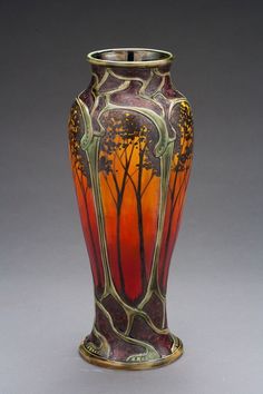 a vase with trees painted on it