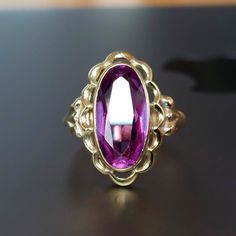 Sweet Alexandrite ring crafted in 14k yellow gold. This ring features an oval faceted Alexandrite bezel set in a decorative yellow gold mount.  Details: This ring is vintage. The deep purple Alexandrite is bezel set in 14k gold. Alexandrite rates 8.5 on Mohs scale. Condition:  The ring is in excellent vintage condition with a thick solid shank.  The stone is in very good condition with only light wear, please inspect photo & video. Measurements: The ring is a US size 6 1/4. Alexandrite stone measures 15 x 7.5 mm. Weight: 5.0g. Please note that I don't accept returns, therefore I describe the items with as much details as possible. Please inspect all photos before purchase, and I would also recommend to try to get a sense of the size, for example measuring a ring that you own and compare th Gold Oval Sapphire Ring In Art Deco Style, Victorian Sapphire Ring In 14k Gold Oval, Victorian Oval Sapphire Ring In 14k Gold, Victorian Oval Yellow Gold Birthstone Ring, Victorian Oval Birthstone Ring In Yellow Gold, Victorian Yellow Gold Oval Birthstone Ring, Oval Amethyst Heirloom Ring With Bezel Setting, Oval Bezel Set Amethyst Heirloom Ring, Victorian Gold Oval Amethyst Ring