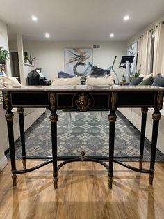 a black and gold console table in a living room