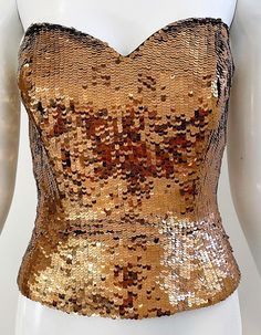 For Sale on 1stDibs - Beautiful 1990s OLEG CASSINI bronze fully sequins strapless silk bustier top ! Features thousands of hand-sewn sequins throughout the entire piece. Full Sequined Fitted Corset For Party, Glamorous Sequined Corset For Party Season, Sequined Corset For Party Season, Glamorous Sequined Corset For Night Out, Gold Strapless Corset For Party, Metallic Fitted Corset For Party, Glamorous Strapless Sequined Corset, Strapless Sequin Tops For Party Season, Strapless Sequined Corset For Night Out