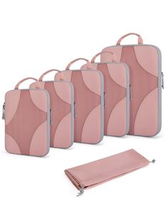 four pieces of pink and grey luggage with matching zippers on each side, set against a white background