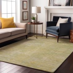 a living room with two couches and a rug on the floor in front of a fireplace