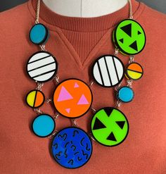 Patterned necklace is a quirky, fun accessory. It would look great as a statement piece to complete your everyday outfit. The necklace is made from multiple pieces of coloured perspex. These are layered on a clear background and have a bold black outline. They are all linked to a curb chain using jump rings.  If you have any questions drop us a line.💌 We are more than happy to help.😁 To clean your necklace you can simply wipe with a glasses cloth or soft cloth to remove finger marks. Acrylic is a fragile material so please store in a jewellery box to prevent damage.  As ever for safety please keep away from small children. Retro White Necklace For Party, White Retro Party Necklace, Multicolor Plastic Jewelry For Party, Modern Resin Jewelry For Party, Modern Resin Jewelry For Parties, Handmade Bold Resin Jewelry, Fun Multicolor Plastic Necklace, Bold Handmade Resin Jewelry, Fun Plastic Jewelry For Party