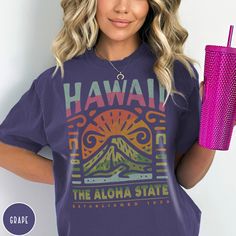 "Show off your love of the Aloha State and its majestic volcanoes with our Hawaii State Shirt! This crewneck makes a great family vacation trip gift, and is all about embracing the great outdoors. It features a custom vintage design that showcases the beauty of Mount Kilauea inside Hawaii Volcanoes National Park. The Comfort Colors 1717 garment-dyed tee has a comfy, lived-in feel that is perfect for hiking, camping, or wherever your day may take you. Grab one now and hit the beach (or the couch!) PLEASE NOTE This is a standard unisex size Comfort Colors Tee. For an oversized tee, please size up. If you are looking for an oversized \"T-shirt Dress\" look, we recommend sizing up 2 sizes. Please review the size chart to ensure you receive the fit you want.---Unisex Crew Neck----- *Product Des Popular Hawaii Shirts, Cheap Tropical Print Graphic Tee, Cheap Hawaiian Beach T-shirt, Retro T-shirt For Vacation, Surf Tee Billabong Women's, Cheap Hawaiian Style Graphic Print T-shirt, Honolulu Hawaii Vacation, Hawaii Crewneck, Hawaii Tshirt