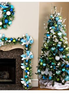 two decorated christmas trees in front of a fireplace