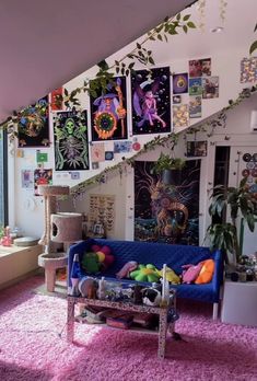 a living room filled with furniture and lots of pictures on the wall next to a window