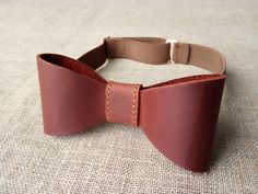 "Brown color leather Bow tie. ►Bow tie made of mat genuine cowhide leather (calf leather) with a waxy coating. ►It is a unique accessory to have a perfect outfit on the wedding, entertainment or in the everyday life. ►You can personalized this bow-tie with name, date, initials or personal logo and it could become a perfect gift. Please, let me know which Name, Initials or Date would you like by selection Menu and add all necessary information to the window \"Personalization\" or to the \"Note To Classic Red Bow Tie For Gift, Elegant Brown Bow Tie With Bow Tie Back, Father's Day Brown Formal Bow Tie, Elegant Brown Adjustable Bow Tie, Classic Detachable Bow As A Gift, Elegant Brown Bow Ties, Dapper Bow Tie With Decorative Bow For Gifts, Dapper Bow Tie As A Gift, Dapper Adjustable Bow Tie With Detachable Bow