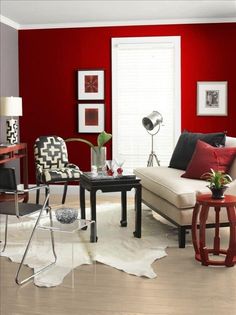 a living room filled with furniture and red walls