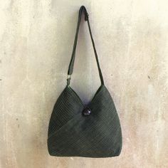 Vinita's flair for style and Thai elegance is evident in the modern design of this leaf green hobo bag. A removable coin purse adds to its versatile allure. Two exterior pockets are camouflaged among the diagonal pintucks that shape the cotton shoulder bag. The fully-lined interior includes two open pockets as well as a zipper pocket. The shoulder strap's length is adjustable and an ornate rain tree wood button closes the bag. Green Hobo Bag With Adjustable Strap For On-the-go, Green Rectangular Hobo Bag With Detachable Handle, Khaki Hobo Shoulder Bag With Removable Pouch, Versatile Green Handheld Bag, Versatile Green Handheld Shoulder Bag, Green Hobo Bag With Detachable Handle, Everyday Hobo Satchel Bag With Single Handle, Green Handheld Shoulder Bag With Single Handle, Everyday Handheld Hobo Bag With Single Handle