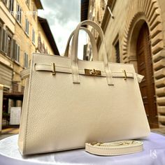 This bag has been made of the best genuine leather by local master crafters of Florence in Italy, designed for women who only accept premium Italian quality and luxury leather bags and modern Italian fashion. . Size: Height: 24 cm / 9.45 inches Width: 34 cm / 13.39 inches Depth: 14 cm / 5.51 inches . The story of this bag: In the heart of Florence, amidst the cobblestone streets and Renaissance architecture, lies a workshop where tradition meets innovation. It is here that skilled artisans craft High-end Gold Box Bag For Travel, High-end Gold Tote Bag, Timeless Bags With Gold-tone Hardware, High-end Gold Box Bag For Daily Use, High-end Gold Tote Box Bag, High-end Gold Travel Bag, Elegant Everyday Satchel With Gold-tone Hardware, Luxury Beige Box Bag For Daily Use, Designer Gold Box Bag With Double Handle