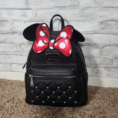 Loungefly Disney Minnie Mouse Bow Faux Leather Mini Backpack. Brand New With Tags. Black Quilted Faux Leather Faux With Small Mickey Mouse Stud Details. Iconic White Red Polka Dot Inside Pattern Faux Leather Outer Shell With 2 Way Top Zipper Closure. Fully Lined Interior Front Zipper Pocket. Adjustable Shoulder Straps. Top Carry Handle. Measures 9" X 10.5" X 4.5" *Dog Friendly Home *Smoke Free Home New To Poshmark? Use My Code Thepardeeplace To Save $10 Off Your First Order When You Sign Up! Dis Black Minnie Mouse Standard Backpack, Black Mickey Mouse Backpack For Daily Use, Disney Leather Backpack For Disney Trips, Minnie Mouse Backpack For Daily Use, Cute Black Minnie Mouse Backpack, Black Minnie Mouse Backpack For Everyday Use, Cute Black Mickey Mouse Backpack, Black Minnie Mouse Bag For Disney Trips, Trendy Black Minnie Mouse Bag