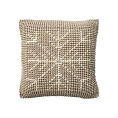 a beige pillow with white dots on the front and back, sitting against a white background