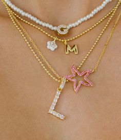 Icy & Luxe! Our statement initial necklace features a jumbo-sized, 14K Gold-plated blingy CZ letter pendant set on a hypoallergenic (allergy-free) Gold-plated ball chain necklace made of hypoallergenic brass metal. Perfectly dainty and lightweight. Choose your frosty initial from the drop down. Limited supply only. Preppy Gold Necklaces, Preppy Jewelry Necklaces, Necklace Stacking Gold, Gold Necklace Stack, Necklace Stacks, Summer Jewelry Trends, Necklace Combo, Lucky Charm Necklace, Necklace Stack