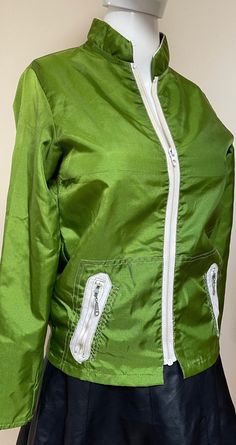 "This 1970s vintage Sears & Roebuck windbreaker is EVERYTHING!  Its amazingly saturated apple green color is sooooooo 1970s retro cool. The jacket fabric has an awesome sheen too!  All the accents for the zipper, collar, pockets, etc are in white -- which POPS against the lime green.  This jacket also has THE coolest zipper pockets! The unique zig zag white accent stitching by the pockets is an incredibly cool detail.  One glance at this and anyone can see it's a 1970s vintage windbreaker -- and one of the best still in such pristine condition!   The originally Sears tag is totally delightful! This gem was probs originally sold as a campus / athletic windbreaker -- but its perfect for today as cutting edge retro streetwear.  Unisex adult, of course. 💥Condition: Excellent vintage condition Vintage Green Windbreaker For Fall, Vintage Green Windbreaker For Outdoors, Vintage Green Windbreaker For Outdoor, Retro Green Hooded Windbreaker, Retro Green Windbreaker For Outdoor, Retro Green Long Sleeve Windbreaker, Retro Green Windbreaker, Retro Green Nylon Windbreaker, Retro Green Windbreaker For Spring