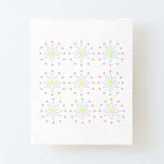 a white canvas with pink, yellow and blue flowers on it's edges is featured against a white background