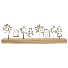 a wooden stand with trees and stars cut out of it's sides, on top of a white background