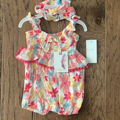 Brand New With Tags Jessica Simpson Baby Romper. Size 3-6 Months, 24-27”, 12.5-17 Lbs. Features A Beautiful Spring/Summer Floral Print, Wooden False Buttons On Front, Tie Straps, Ruffle/Pom Pom Ruffle, And A 3 Snap Closure On Bottom. Comes With A Matching Headband. No Rips Or Stains. Feel Free To Ask Questions! Playful Bubble Romper For Spring Vacation, Playful Bubble Romper For Vacation In Spring, Playful Bubble Romper For Beach In Spring, Playful Spring Beach Bubble Romper, Casual Multicolor Bubble Romper For Summer, Fun Summer Playwear For Babies, Casual Yellow Bubble Romper For Summer, Playful Multicolor Bubble Romper For The Beach, Casual Multicolor Bubble Romper For Beach