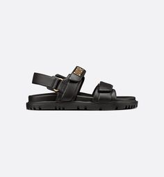 The black lambskin Dioract sandal has a modern silhouette. The style features an anatomical-shaped sole made with an ultra lightweight and comfortable leather. Scratch bands further enhanced by a gold-finish metal 'DIOR' signature on the superior band complete the design. The sandal will lend a contemporary touch to any look.. 41.5 Dioract Sandal, Black Round Sunglasses, Dior Sandals, Christian Dior Couture, Dior Couture, Sandals Black, Lady Dior, Luxury Handbags, Black Sandals