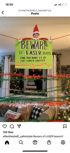 an elf is standing in front of a sign that says beware of laser beams