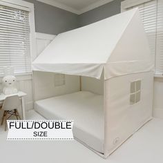 a bed with a white tent on top of it