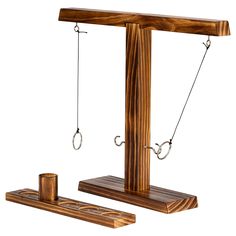 a wooden balance scale with two ropes attached to it