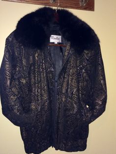 This is a one of a kind item that is both stylish and warm. High quality Black suede is embellished with a unique, subtle gold paisley print, has a satin lining,  a warm inner lining,  and a detachable fox collar. There is banding along the bottom of the 3/4 length coat and on the sleeves, which helps to add warmth.  This jacket goes well with jeans and dress. Perfect for cool fall evenings into the winter.   The size says small, but it is very roomy and will fit ladies size 6 to 10.   It was worn just a few times and  shows no signs of wear or storage.  Comes from a smoke free and pet free home I will entertain offers.  I have other pictures as well. Please contact me with any questions.  Thank you! Luxury Gold Outerwear For Evening, Elegant Gold Winter Outerwear, Gold Formal Winter Outerwear, Gold Embellished Outerwear For Formal Occasions, Vintage Gold Outerwear For Formal Occasions, Gold Vintage Outerwear For Formal Occasions, Gold Vintage Formal Outerwear, Vintage Gold Outerwear For Fall, Vintage Gold Long Sleeve Outerwear