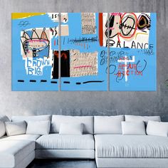 three pieces of artwork on a wall in a living room with white couches and blue walls