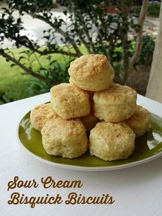 a plate full of biscuits sitting on top of a white table next to a tree