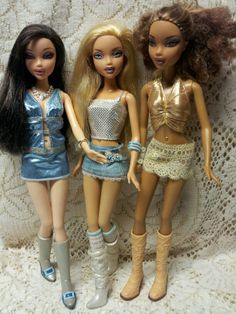 three dolls are standing next to each other