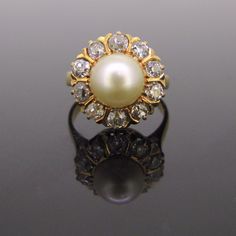 Weight: 6gr Metal:18kt yellow gold  Stones:1 Cultured Pearl *Diameter:8.74mm x 8.73mm   Others:10 old cut diamonds *Total carat weight:1ct approximately *Cut:I/J *Colour:SI Condition:Very Good  Comments:This ring is fully made in 18kt yellow gold. It is set in its centre with a creamy cultured pearl surrounded by 10 old cut diamonds with an approximate total carat weight of 1ct. The ring is not marked and it has been tested 18kt gold.  Pearl symbolises purity and innocence; they are usually wear Pearl Rings Vintage, Cultured Pearl Ring, Gold Bridal Jewellery Sets, Pearl And Diamond Ring, Gold Earrings Designs, Diamond Cluster Ring, Diamond Cluster, Gold Pearl, Pretty Jewellery