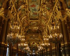 an ornate room with chandeliers and paintings on the ceiling