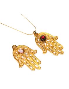 "Beautiful large gold plated Hamsa charm necklaces to choose from. Flower and stone can be ordered at a different color so if you have one in mind just let me know. Approx size 1 3/4\" long and 1 1/4\" wide Since the Hamsa hand is considered a gift of love it makes the perfect gift idea. The Hamsa hand is a symbol that's been around for thousands of years and is believed to protect and shield against the evil eye, generate positive energy, provide good fortune, health, prosperity and happiness. Gold Evil Eye Jewelry For Blessing, Gold Amulet Charm Necklace With Large Pendant, Gold Spiritual Crystal Necklaces Nickel Free, Gold Spiritual Dangle Crystal Necklace, Gold Plated Charm Necklaces With Large Pendant, Traditional Gold Evil Eye Necklace, Nickel-free Gold Plated Spiritual Necklaces, Spiritual Gold-plated Necklaces For Blessings, Gold Evil Eye Pendant Charm Necklace