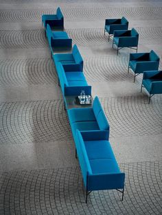 blue couches and chairs are arranged on the floor