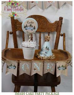 a cake party package for a baby's first birthday is displayed on a wooden chair