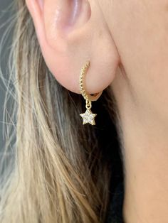 925 sterling vermeil CZ star charm huggie hoop earrings.14KT gold plate over sterling silver.Cubic zirconia stones.Hoops measure 12mm in diameter.Star charm measures 5mm.Hinge style hoop with latch back.Hoops sold as a pair.Follow us on instagram @pennyweightsjewelry! Dainty Yellow Gold Huggie Earrings With Star Charm, Yellow Gold Star-shaped Tarnish Resistant Huggie Earrings, Everyday Yellow Gold Huggie Earrings With Star Charm, Gold Huggie Hoop Earrings With Star Charm, Gold Dainty Huggie Earrings With Star Charm, Yellow Gold Huggie Earrings With Star Charm, Dainty Gold Star Huggie Earrings, Yellow Gold Star Shaped Huggie Earrings, Silver Flats