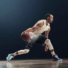 a basketball player dribbles the ball while wearing blue and white shoes on a court