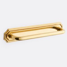 a gold door handle on a white background