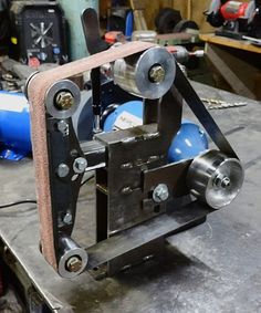 a machine that is sitting on a table in a room with other tools and equipment